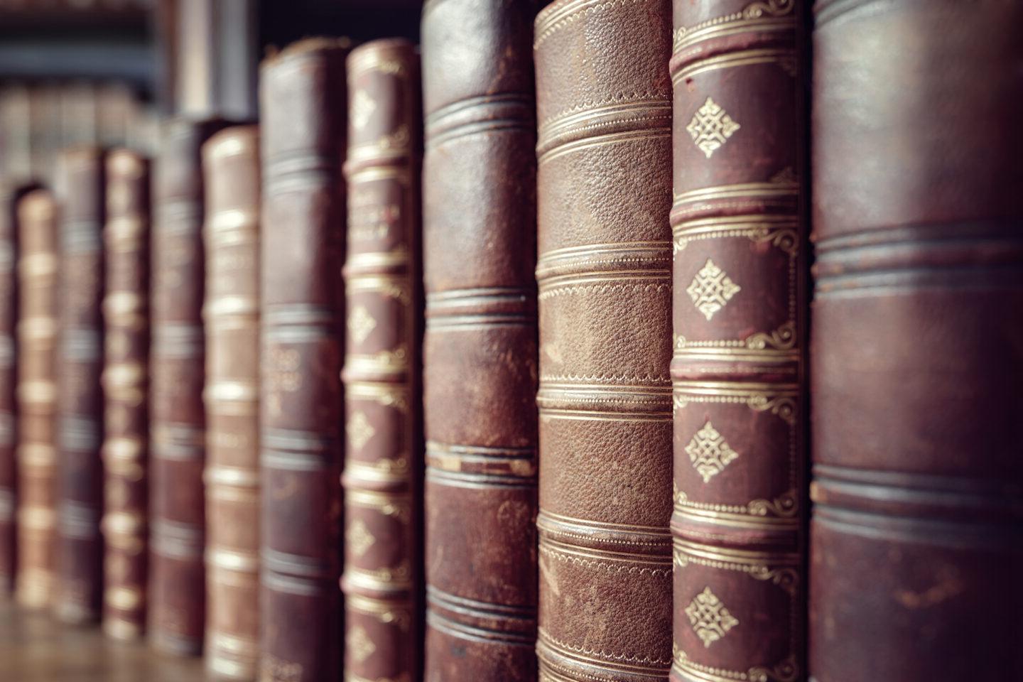 Old leather bound vintage books in a row